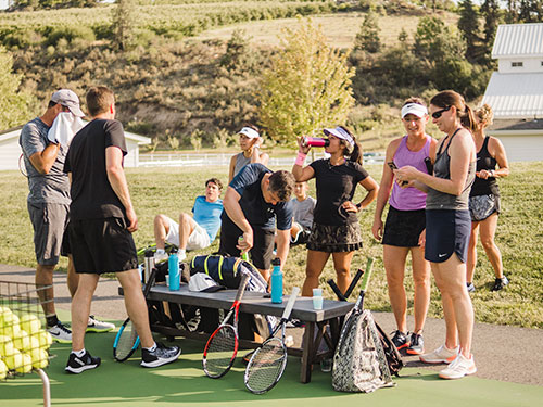 A group of tennis players take a break on the sidelines. Washington state, tennis players, resort